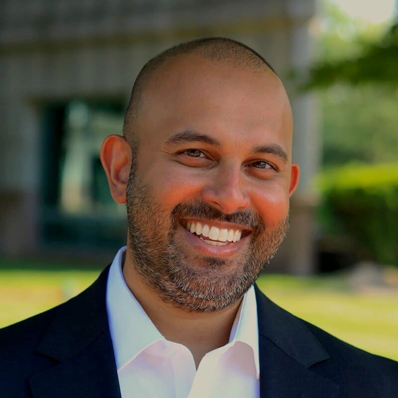 Nishan Seal smiling in a suit jacket